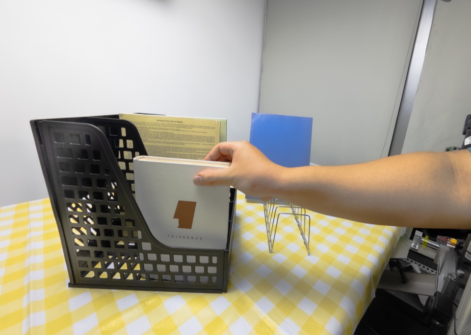 Insert a book onto a shelf, human demonstration frame 1
